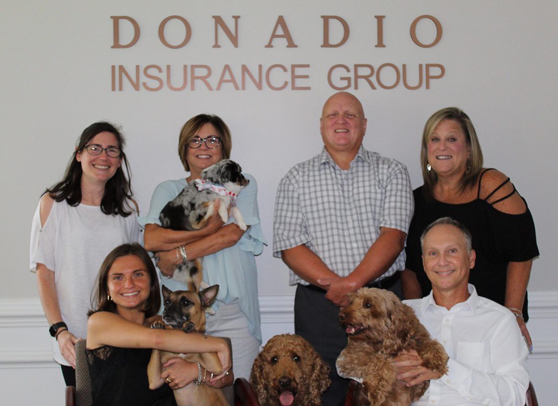 Insurance Solutions - Donadio Insurance Group Team Members Together Holding Their Dogs